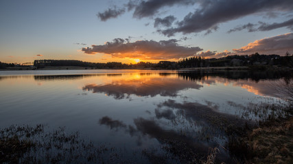 Clouds and sunset at Devesset lake in Ardèche, France