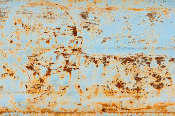 rust covered metal wall,rusty metal texture with blue paint remains