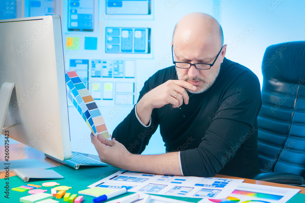 Poster a creative man is developing a graphic design for a mobile application. the work of the designer. a 