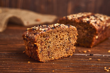 Whole wheat craft bread on wooden background. The concept of healthy food and traditional bakery. Rustic