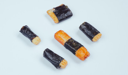 Nori Maki Arare Japan Rice Crackers in seaweed. Macro on white background.