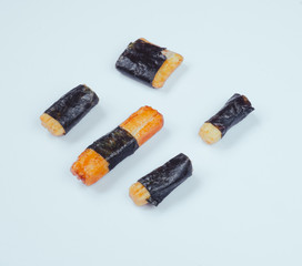 Nori Maki Arare Japan Rice Crackers in seaweed. Macro on white background.