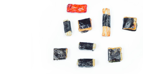 Mix of Asian snack on white background. Japanese nori maki arare rice crackers in seaweed, glaze peanuts. Close up with Space for text.