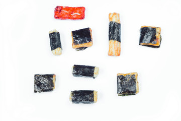 Mix of Asian snack on white background. Including Nori Maki Arare rice crackers in seaweed, glaze peanuts and fried crackers. Close up.