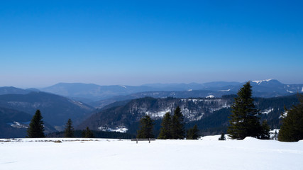 Beautiful view over the mountains in the black forest with stunning blue sky 