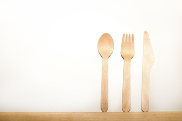 Disposable tableware from natural materials, wooden spoon, fork, knife, eco-friendly. Place for text