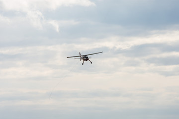 Fototapeta na wymiar small motor plane flying in blue sky