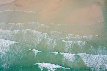 Fototapeta na wymiar Aerial view, tropical beach, top view of the waves on the beautiful sand beach