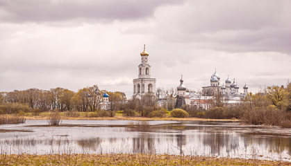 Fototapeta premium The ancient monastery on banks of river in Veliky Novgorod