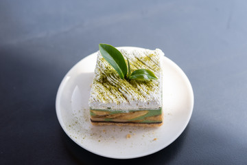 ​View of green tea cake banoffee put on top of wooden table.