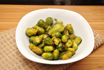 Steaming Hot Roasted Brussel Sprouts in a White Bowl
