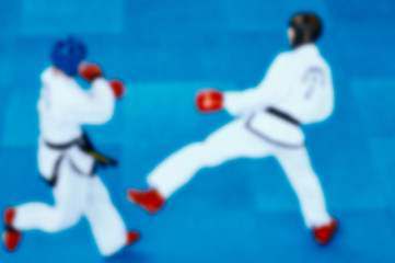 taekwondo blurred background. two men in white clothes on a blue background