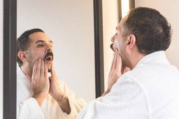 Man applying cream on his face