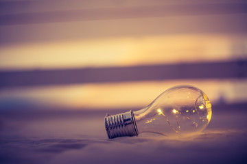 Ideas and innovation: Light bulb with LEDs is lying in the bed. Spot lights in the blurry...