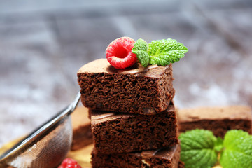 chocolate brownie cake dessert with raspberry and spices on a rustic background