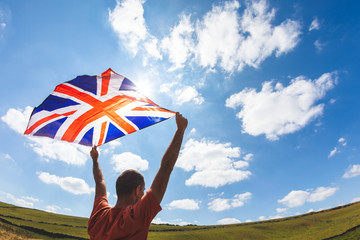 Man flying UK flag in the countryside