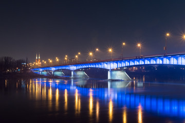 Fototapeta na wymiar Slasko-Dabrowski bridge over Vistula River at night in Warsaw, Poland.
