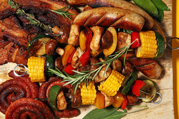 Assorted delicious grilled meat and skewer with vegetable on rustic table