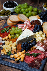 assorted gourmet cheeses and meats, vertical