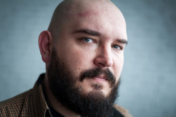 Obraz premium Portrait of a bald man in a shirt with a beard