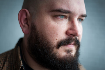 Obraz premium Portrait of a bald man in a shirt with a beard