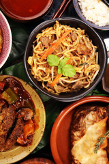 Assorted Chinese food set. Chinese noodles, fried rice, peking duck, dim sum, spring rolls. Famous Chinese cuisine dishes on table. Chinese restaurant