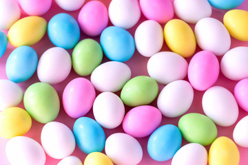 Background Small colorful candy eggs in the stand. Easter celebrate concept. Close up.
