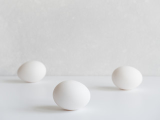 Easter is a minimalistic concept. White chicken eggs on white background