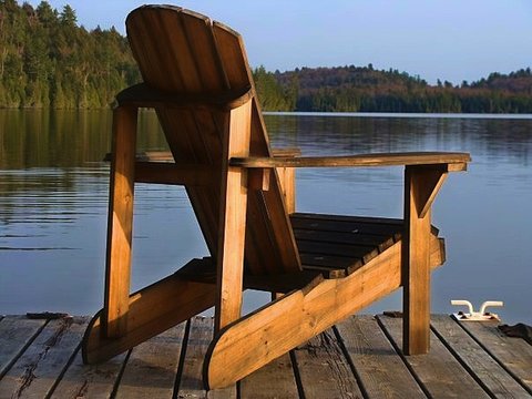 Muskoka Chair On A Dock In Early Evening