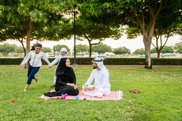 Happy arabian family in a park