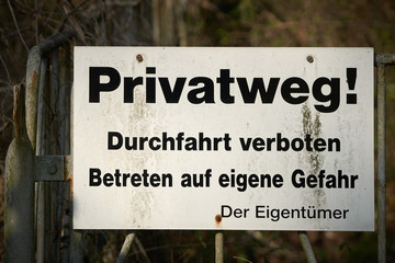 Schild mit der Aufschrift "Privatweg, Durchfahrt verboten, Betreten auf eigene Gefahr"