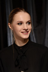 portrait of a young girl in a black shirt on a dark background