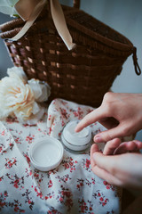 Woman applying skin care cream on hands