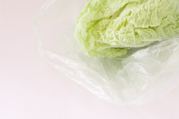 Green salad in plastic bag isolated on white background