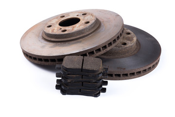 Brake pads and brake discs on white background