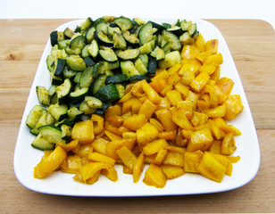 Sauteed zucchini and pepperoni in a white dish, studio shot