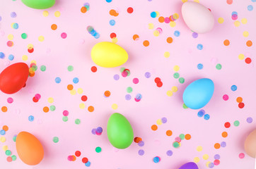 Fototapeta na wymiar Colored Easter eggs on pink background. Flatlay.