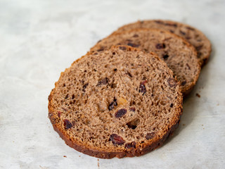 Amazing Chocolate Easter Cake with chocolate drops and dry cherries on gray wooden background. Round slices of cake. Easter concept. Selective focus, close up