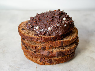 Amazing Chocolate Easter Cake with chocolate drops and dry cherries on gray wooden background. Round slices of cake. Easter concept. Selective focus, close up