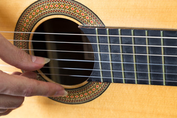 Obraz premium close up photo that the man play guitar with long nail finger.