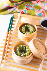 Asian Food concept homemade Dim Sum steamed garlic chives dumplings in Dim Sum Bamboo Steamer Basket on white background
