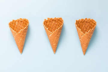 Three Waffle cornet on light blue background.