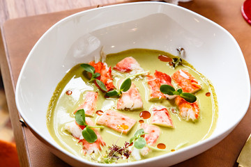 Pieces of crab meat are in green sauce