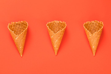 Three Waffle cornet on orange background.