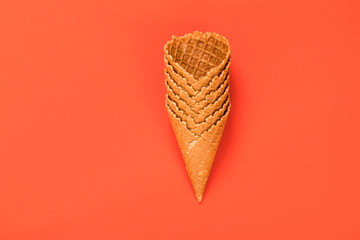 Sweet wafer cone isolated on orange background.