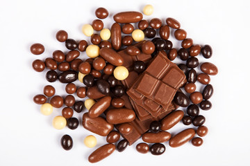 Milk chocolate pieces isolated on white background from top view