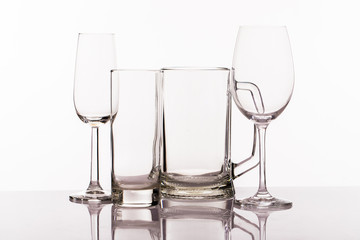 A variety of empty glasses for alcoholic beverages isolated on white background. Close up
