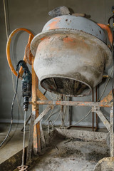 Concrete mixer and hammer drill at the construction site