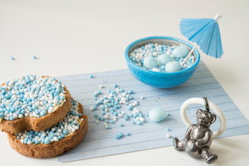 Fototapeta na wymiar rusk with blue and white aniseed balls, Dutch Muisjes, traditional food in The Netherlands when a baby boy is born