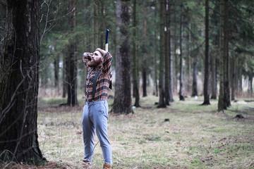 Fototapeta premium A bearded lumberjack with a large ax